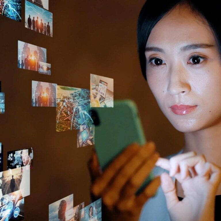 A woman holds her smartphone as ads and videos flow out of it.