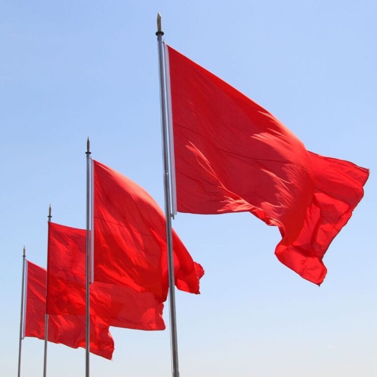 Four red flags on a poles.
