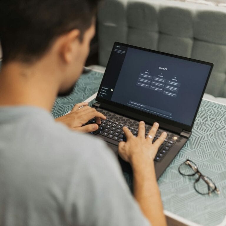 A man on his laptop working in Chat G P T.
